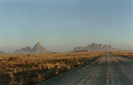 Endless gravel road on the way to the Spitzkoppe of Namibia.