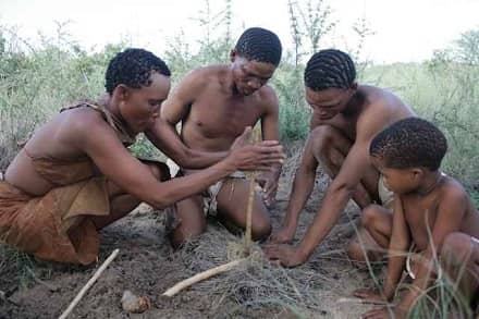 San family making fire with two sticks in the traditional way